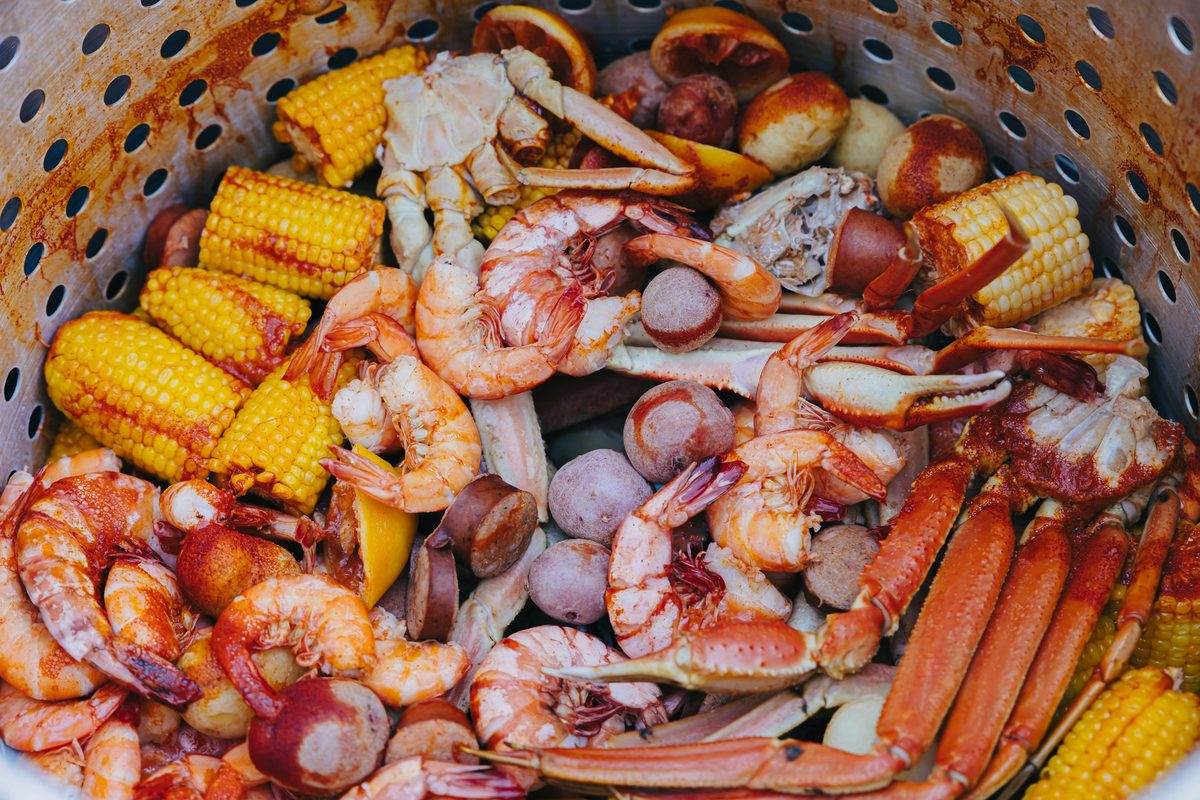 A seafood boil with shrimp, corn, red potatoes, sausage and crab legs