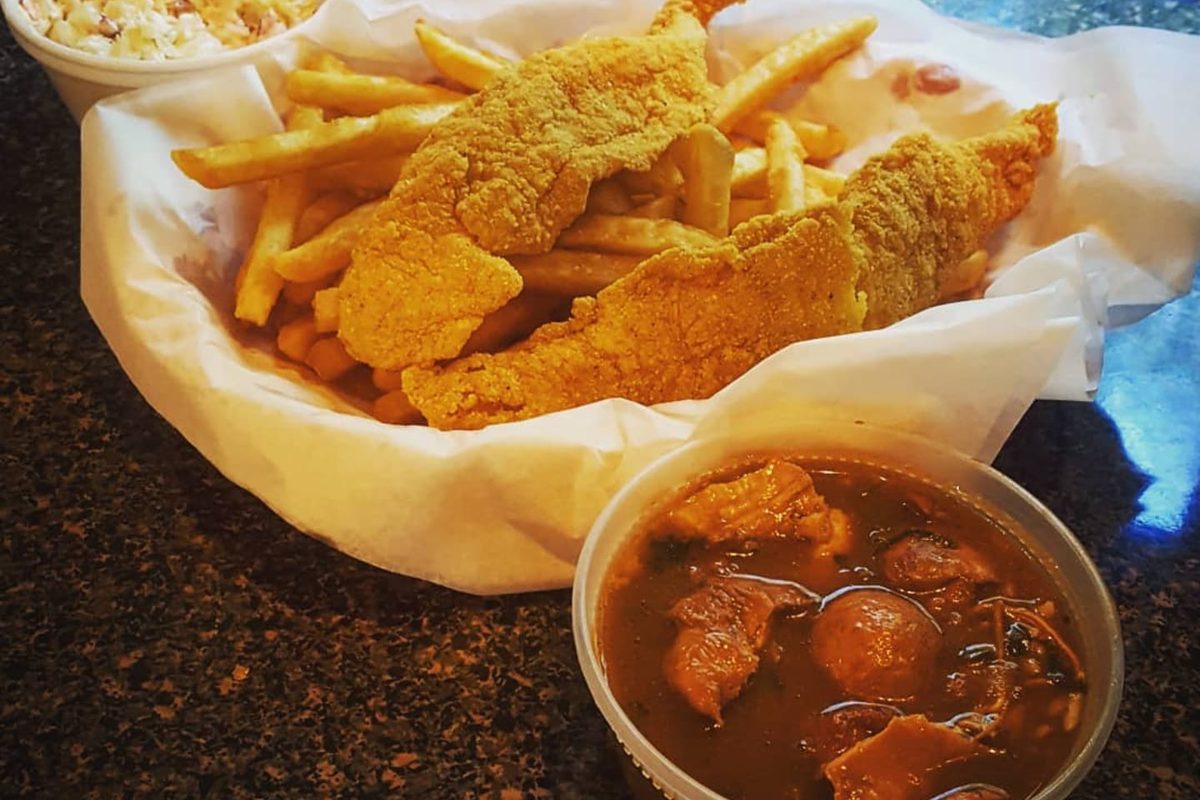 Fried catfish fillets and fries in a basket with a cup of gumbo at Vautrot's Cajun Cuisine in Bevil Oaks